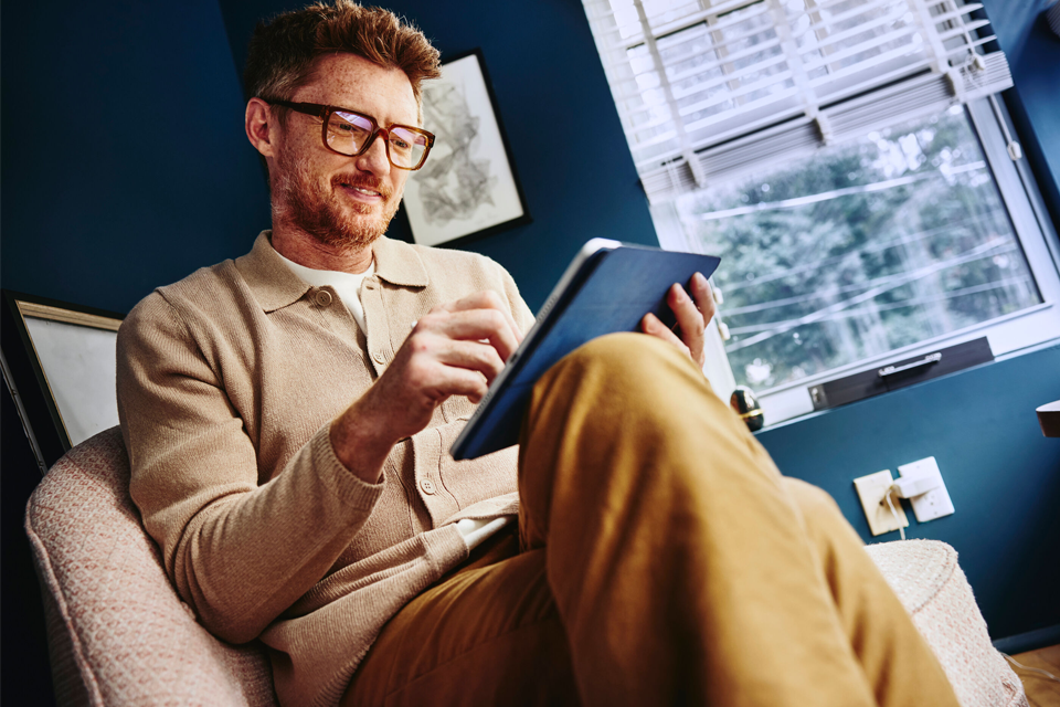 man browsing on a tablet