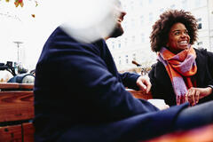 woman and man sitting on a bench