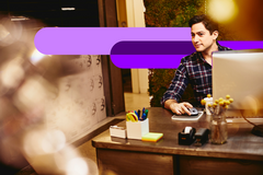young man sitting behind a desk