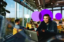man working remotely in a cafe