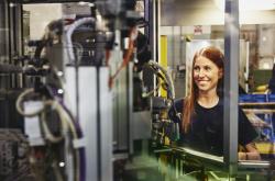 Woman operating a machine on a production site. 