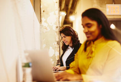 2 women working on a laptop