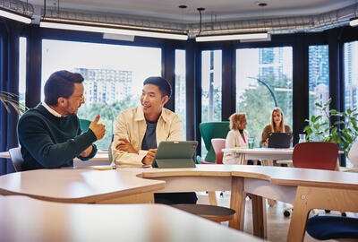 2 males having a discussion at a table