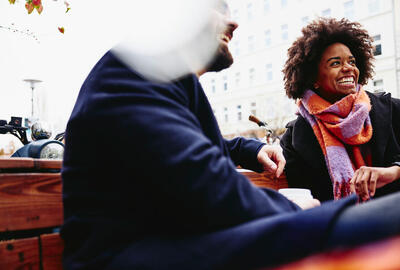 woman and man sitting on a bench