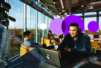man working remotely in a cafe