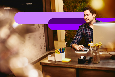 young man sitting behind a desk