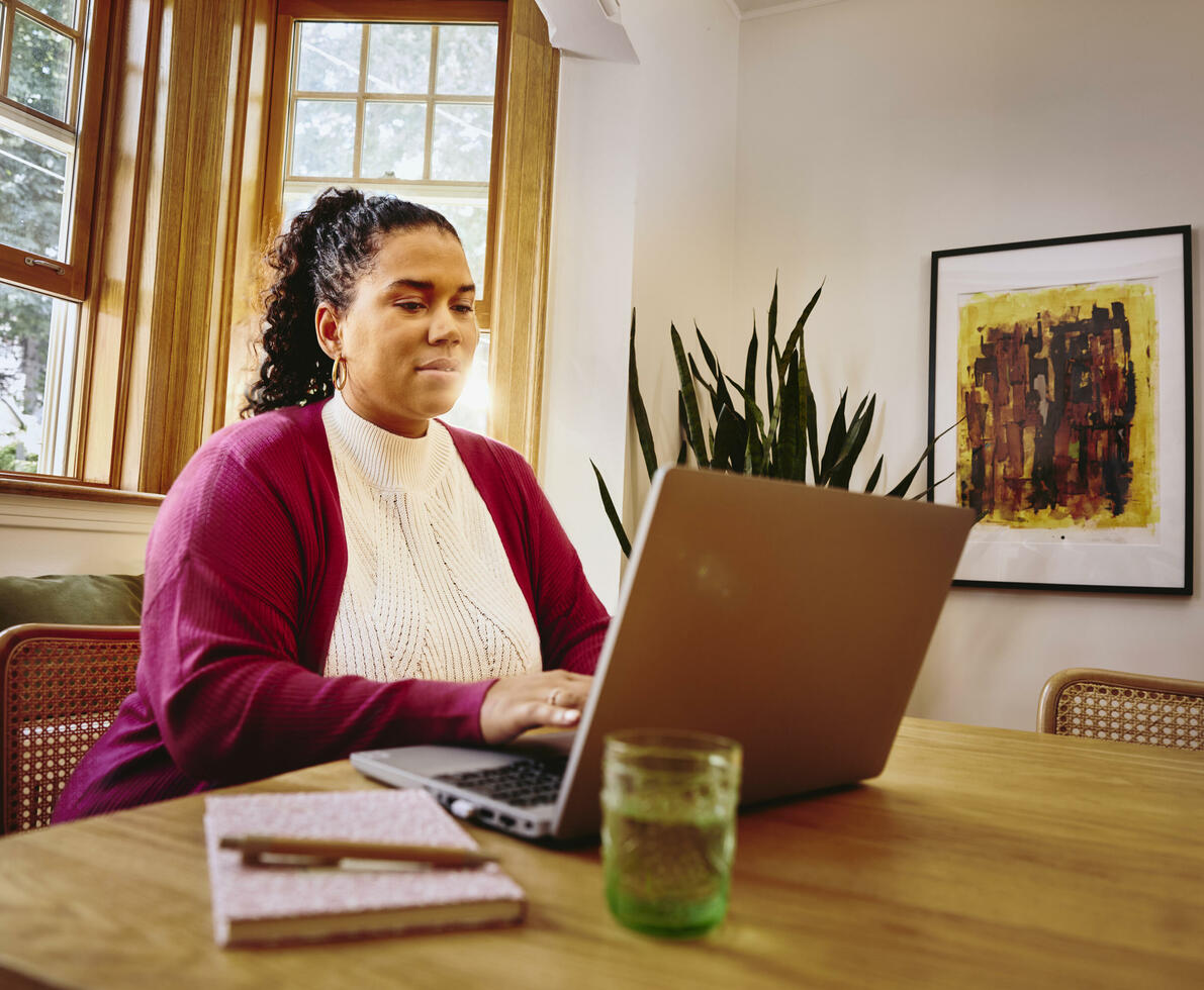 Female working on laptop on a table at home
Female working on laptop on a table at home