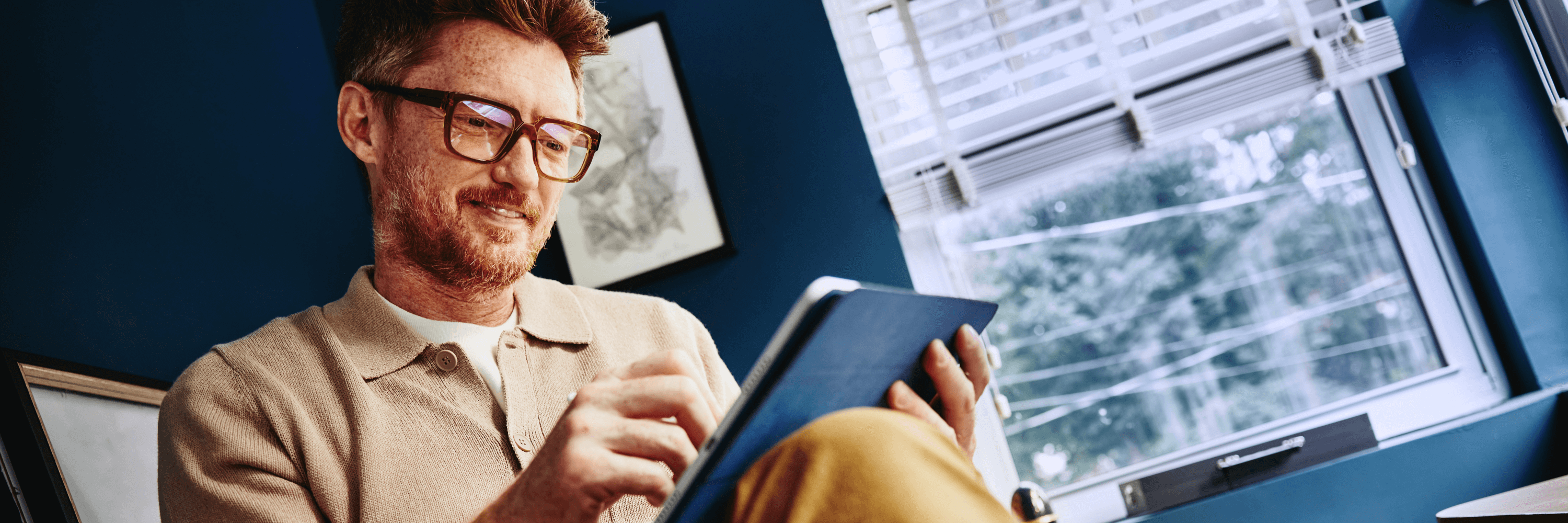 man browsing on a tablet