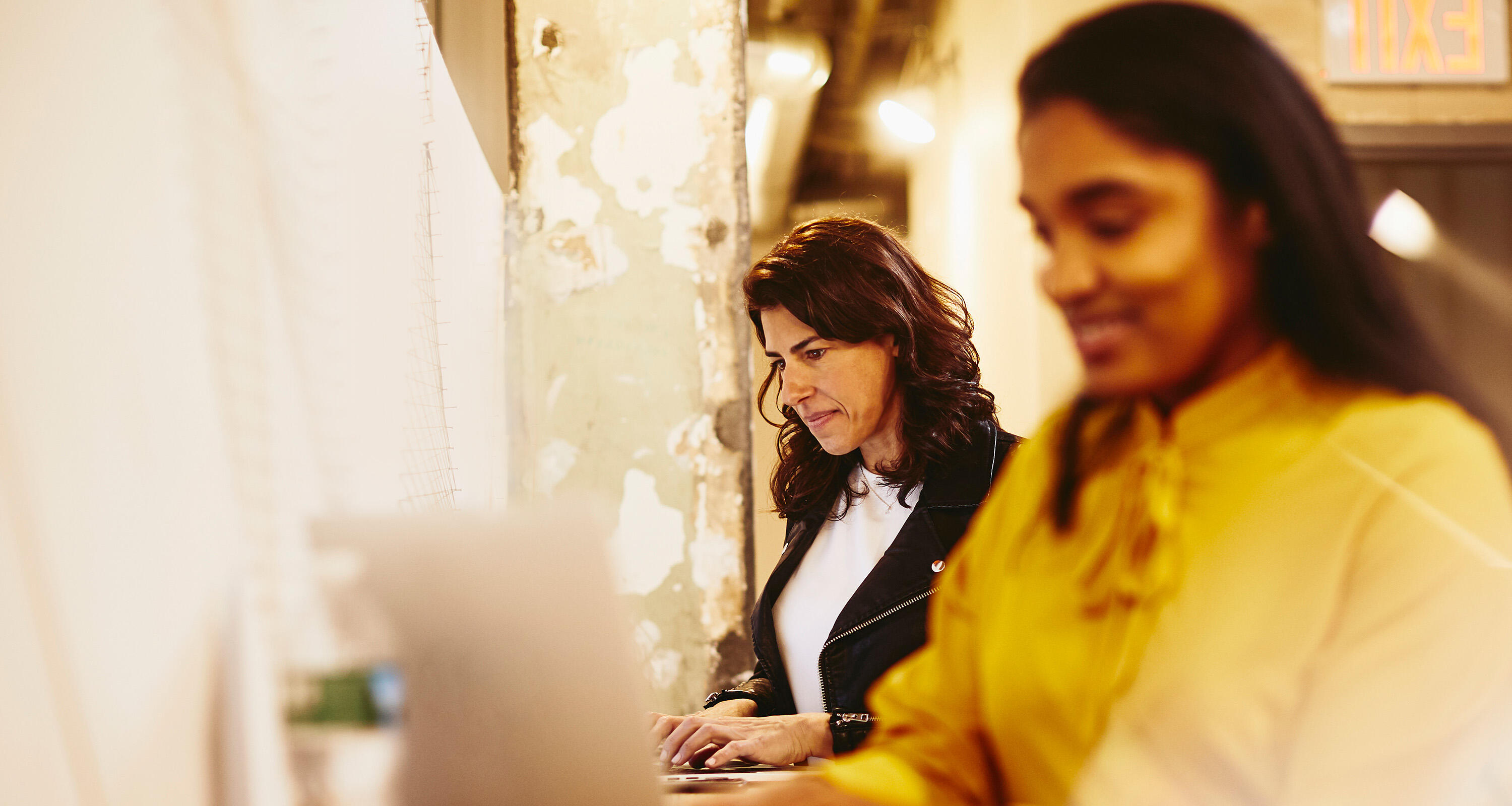 2 women working on a laptop